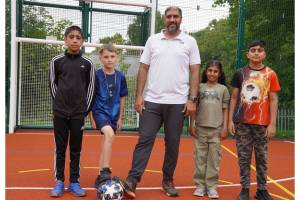 Four children and councillor Jabba Riaz at the multi-use games area at the Horizon Hub