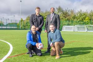 Standing on the artificial pitch are Jack Handsaker, Councillor Jabba Riaz, Alan New, and Martin Collier