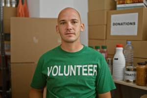 Man wearing green volunteer t-shirt