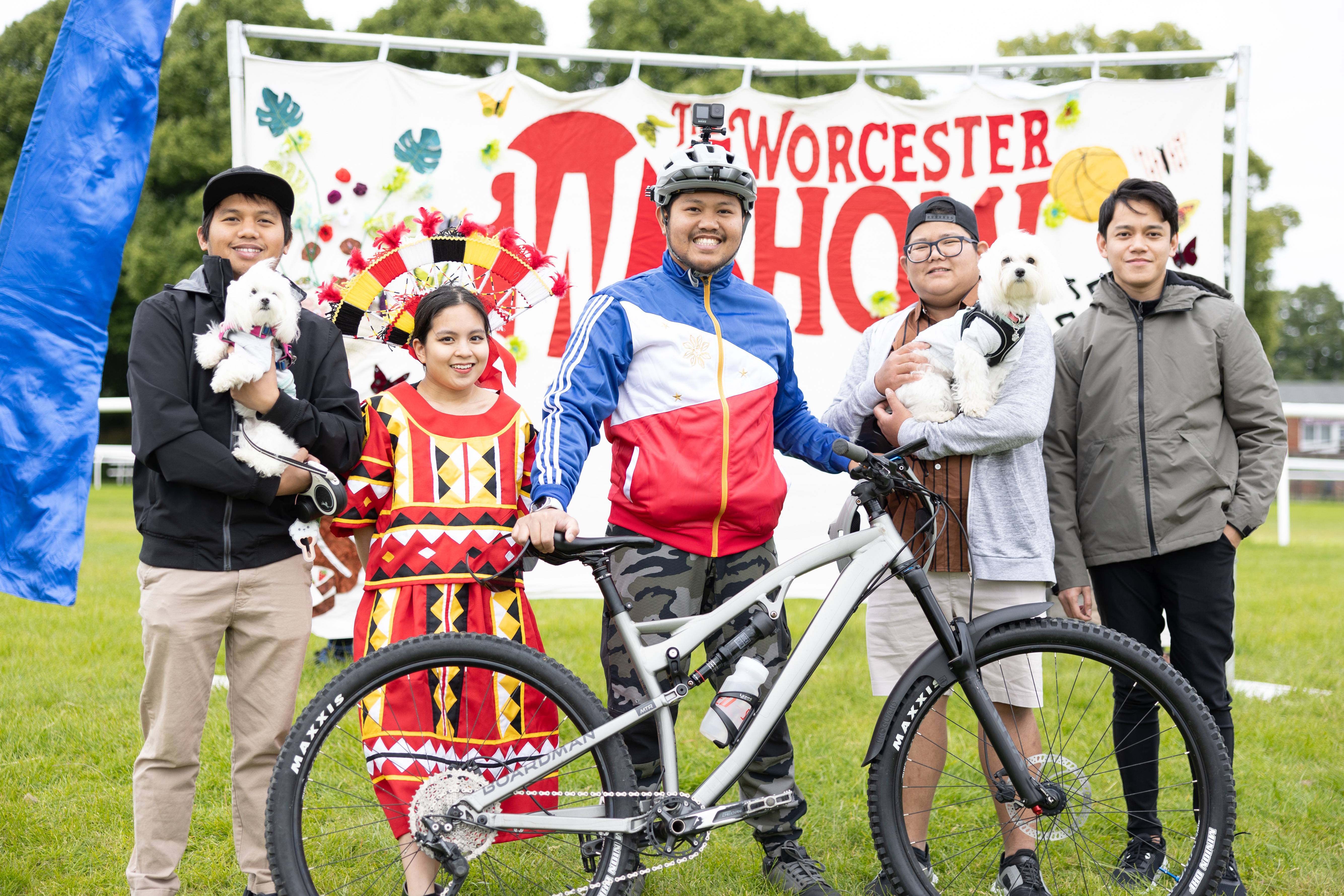 Members of the Worcester England Filipino Association in front of a Worcester Show banner